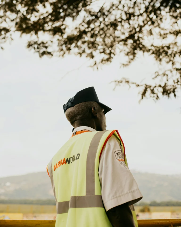 security guard in a yellow Gardaworld vest on an African construction site