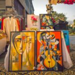 Art is displayed at an outdoor market